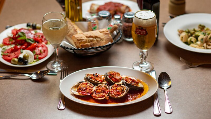 Multiple entrees with focus on Clams casino appetizer